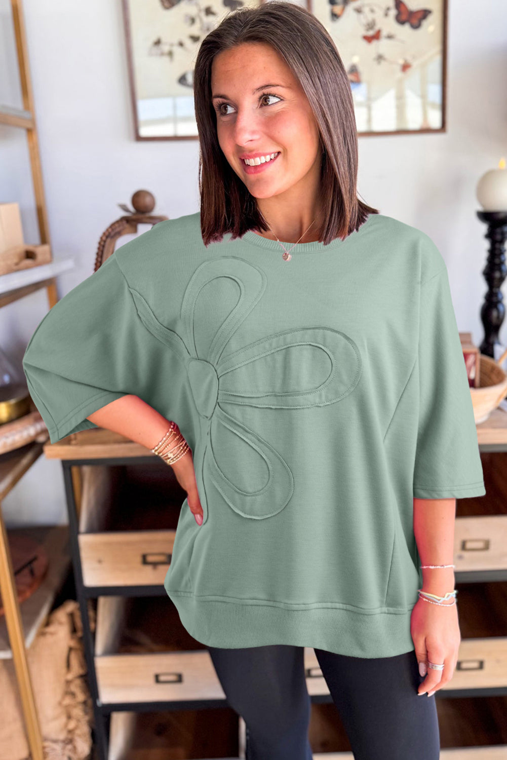 Mommas Hive floral patched half sleeve tunic top in aqua, made of polyester, cotton, and elastane, with colorful floral patches.