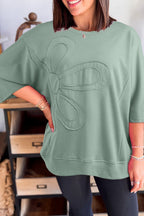 Mommas Hive floral patched half sleeve tunic top in aqua, made of polyester, cotton, and elastane, displayed on a hanger.