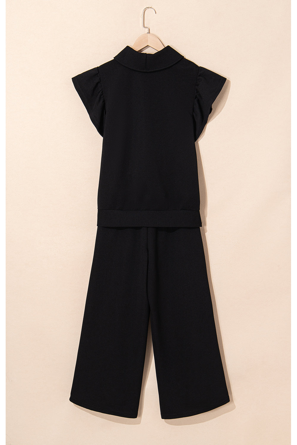 Black textured ruffled sleeve zipped top and wide-leg pants set from Mommas Hive, stylish two-piece pant set with modern design.