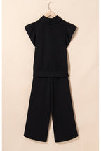 Black textured ruffled sleeve zipped top and wide-leg pants set from Mommas Hive, stylish two-piece pant set with modern design.