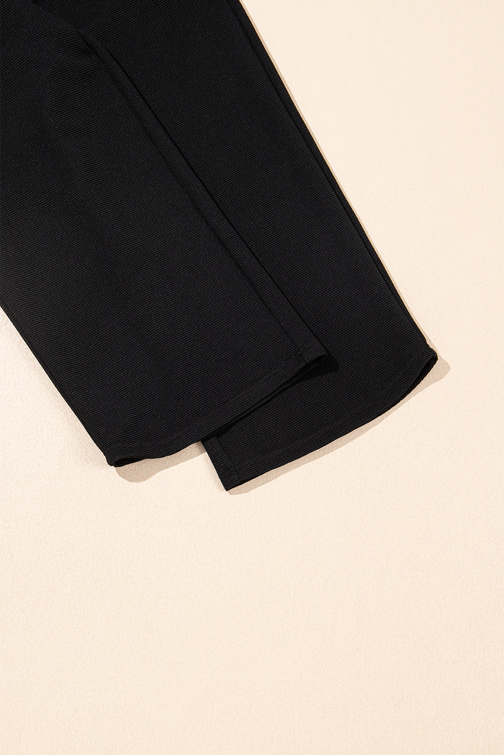 Black textured ruffled sleeve zipped top with wide-leg pants set by Mommas Hive, featuring polyester-elastane fabric and stylish design.