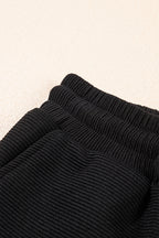 Black textured ruffled sleeve zipped top with wide-leg pants set by Mommas Hive, featuring a stylish two-piece design.