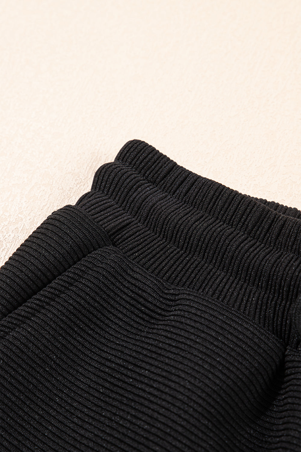 Black textured ruffled sleeve zipped top with wide-leg pants set by Mommas Hive, featuring a stylish two-piece design.