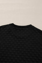 Mommas Hive black checkered textured split pullover top and matching pant set, two-piece casual outfit for women.