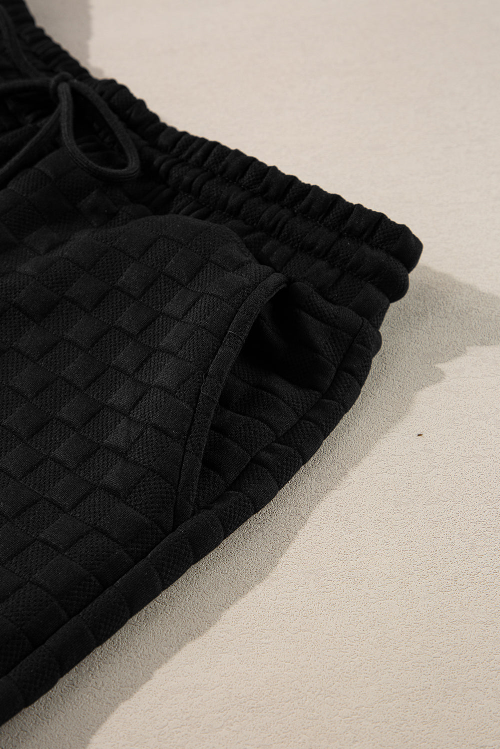 Mommas Hive black checkered textured split pullover top and matching pants set, two-piece outfit with a stylish and comfortable fit