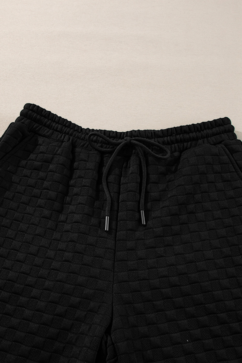 Black checkered textured split pullover top and matching pants set by Mommas Hive, stylish two-piece outfit with comfortable fit.