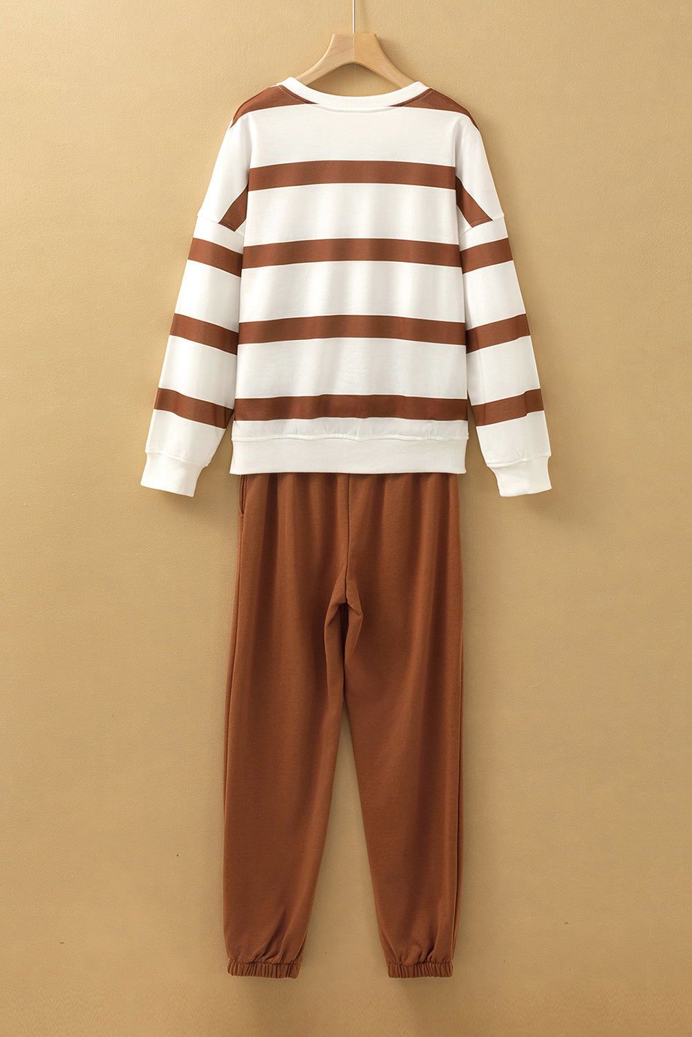Black and red stripe drop shoulder pullover with matching jogger pants from Mommas Hive two-piece set, made of polyester.