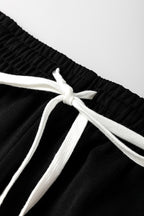 Black stripe drop shoulder pullover and matching jogger pants set from Mommas Hive, casual two-piece loungewear ensemble.