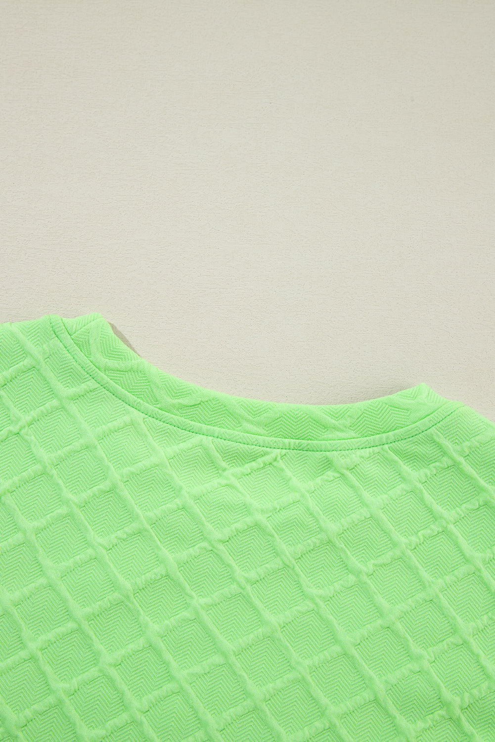 Light green checkered textured tee and matching drawstring shorts from Mommas Hive two-piece set, made of polyester and elastane.
