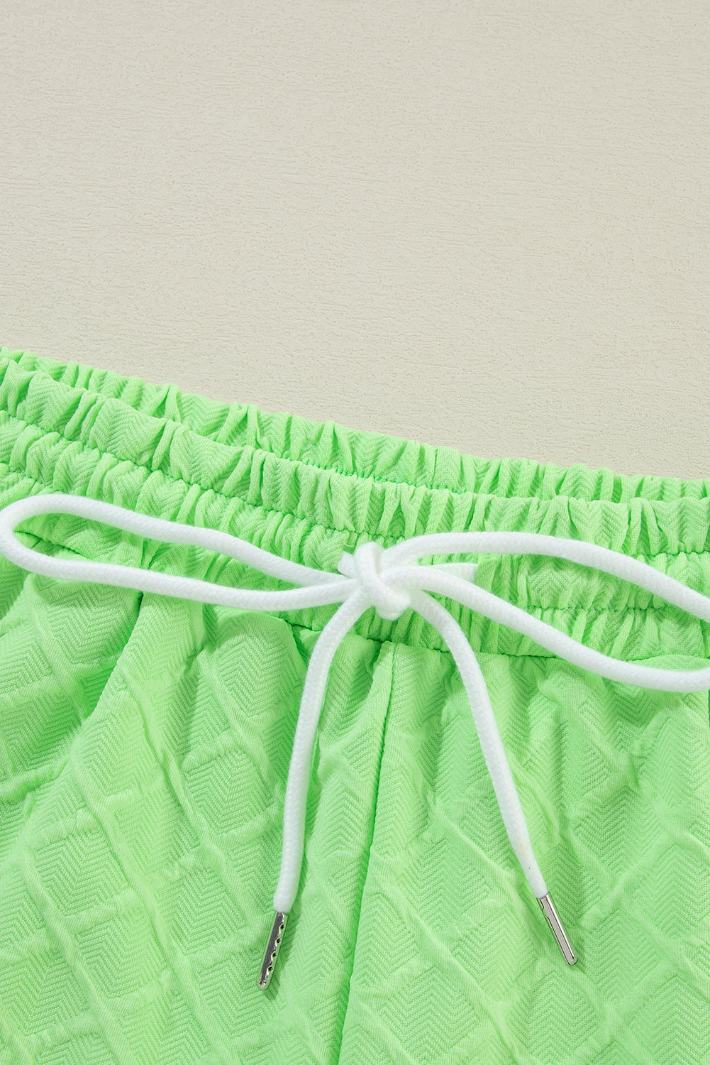 Light green checkered textured tee and matching drawstring shorts from Mommas Hive two-piece set, casual and comfortable for everyday wear.