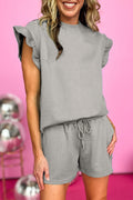 Mommas Hive textured ruffle split top and drawstring shorts two-piece set, made of polyester and elastane, with ruffle details and textured fabric.