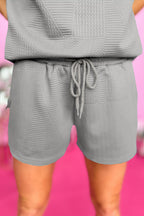 Mommas Hive textured ruffle split top and drawstring shorts two-piece set, polyester blend, stylish and comfortable casual outfit.