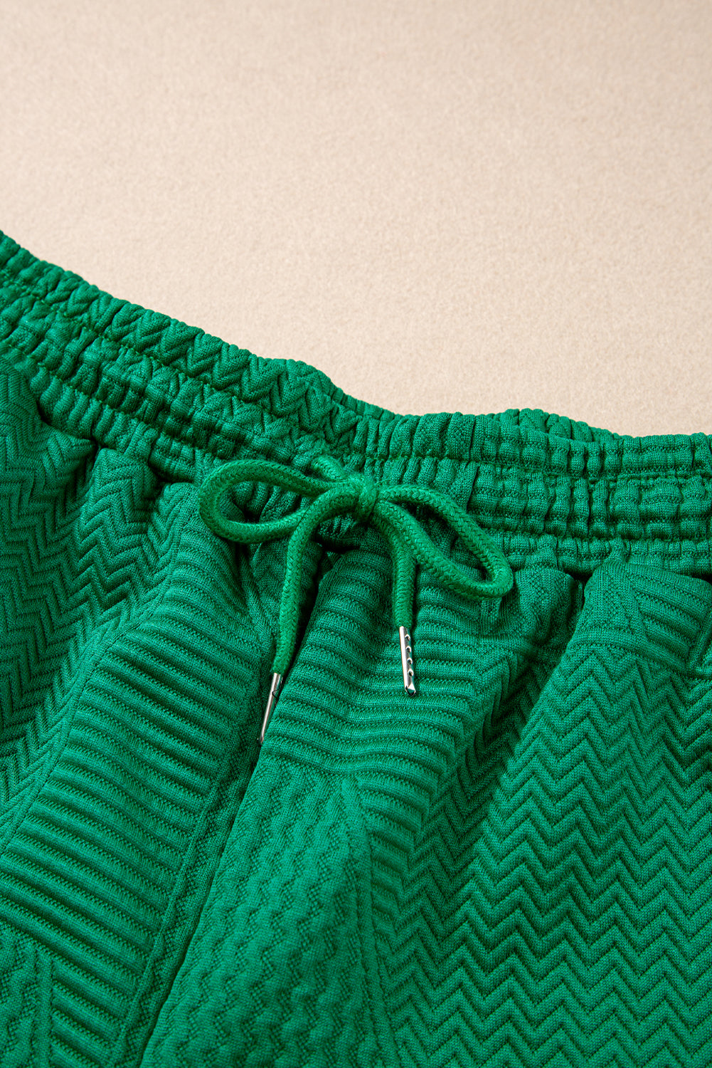Mommas Hive textured ruffle split top and drawstring shorts two-piece set, featuring a stylish split top and comfortable shorts.