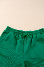 Mommas Hive textured ruffle split top and drawstring shorts two-piece set, featuring short sleeves and relaxed fit.