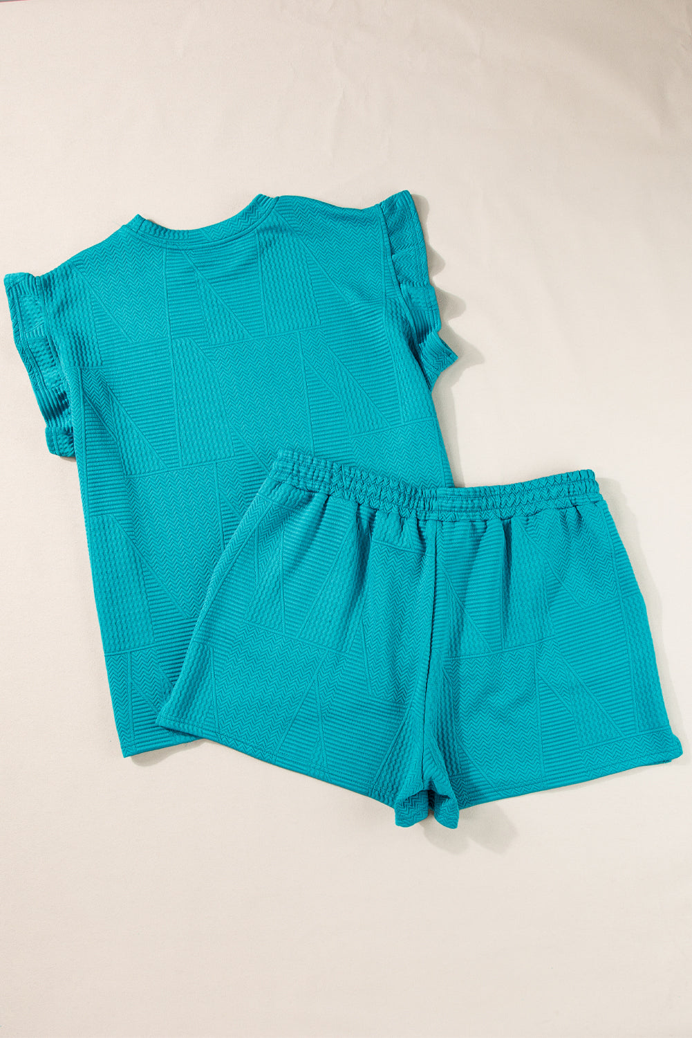 Mommas Hive textured ruffle split top and drawstring shorts two-piece set, polyester-elastane fabric, casual summer outfit.