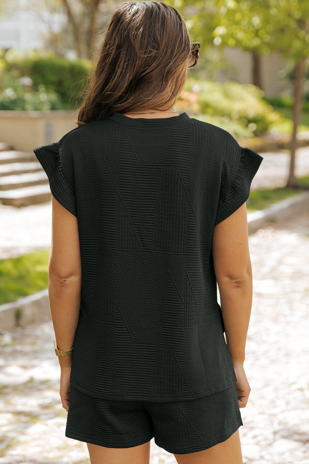 Mommas Hive textured ruffle split top and drawstring shorts two-piece set, soft polyester and elastane fabric, stylish and comfortable.