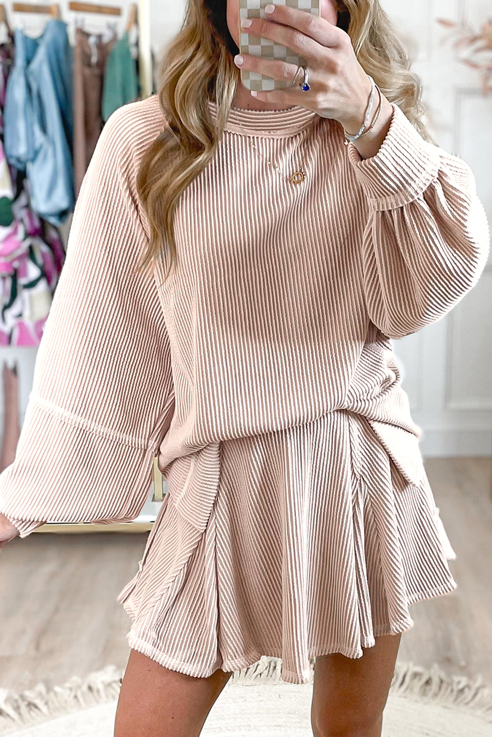 Mommas Hive two-piece set with a jet stream corded lantern sleeve top and high-waist ruffled mini skirt, stylish and modern.