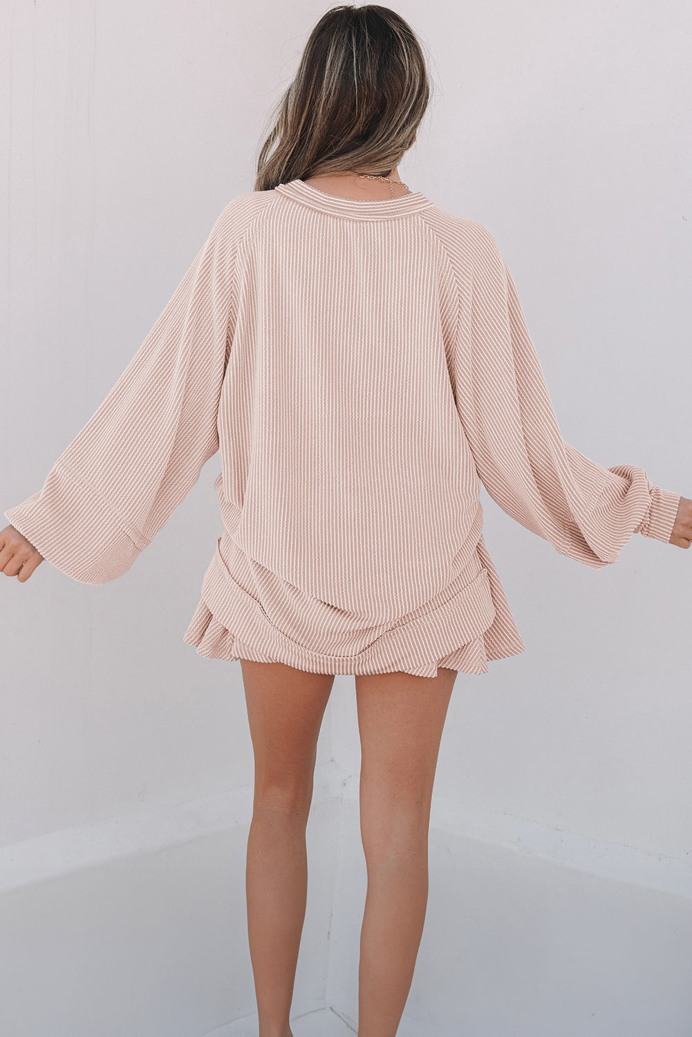 Mommas Hive two-piece set with lantern sleeve top and high-waist ruffled mini skirt, made of polyester, viscose, and elastane.