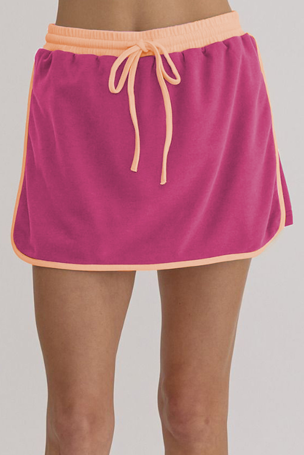 Rose red color contrast loose pullover and lace-up waist skort set by Mommas Hive, featuring a stylish two-piece outfit with comfy fabric.