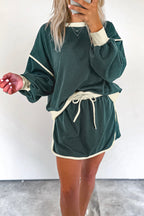 Rose red color contrast loose pullover and lace-up waist skort set by Mommas Hive, featuring a stylish two-piece dress look.