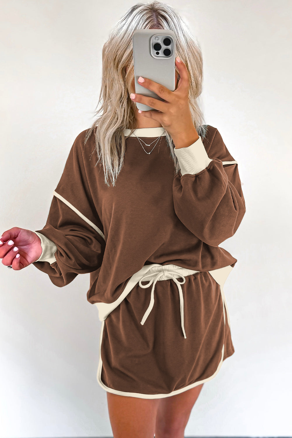 Rose red contrast loose pullover and lace-up waist skort set from Mommas Hive, showing the stylish two-piece outfit.