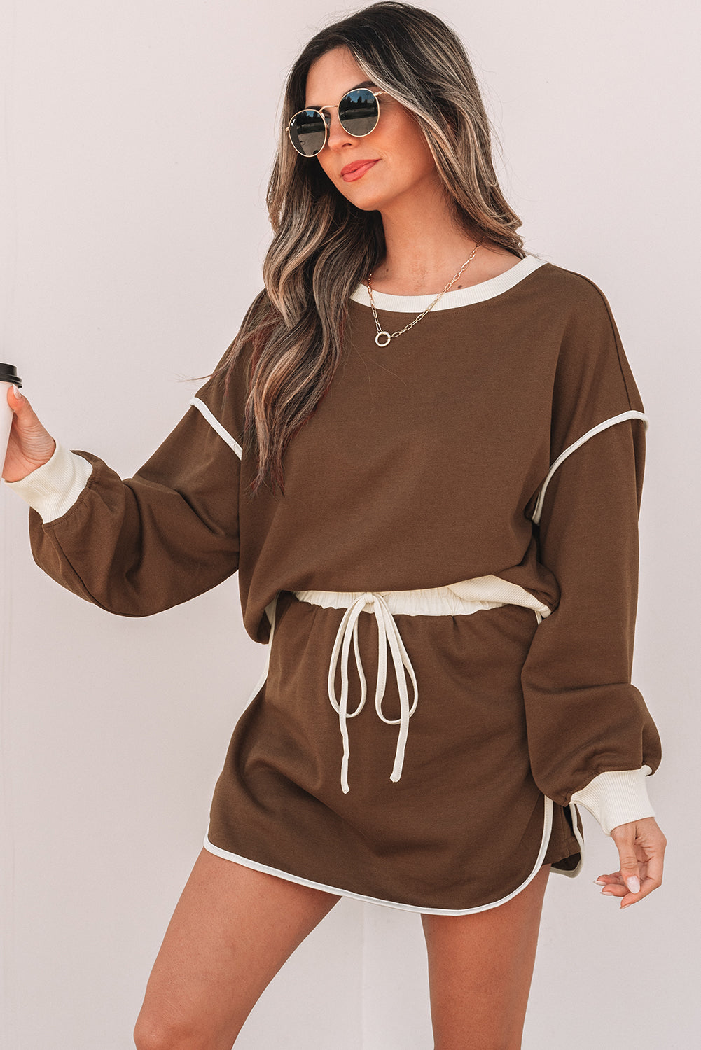 Rose red color contrast loose pullover and lace-up waist skort set by Mommas Hive, featuring a stylish two-piece dress design.