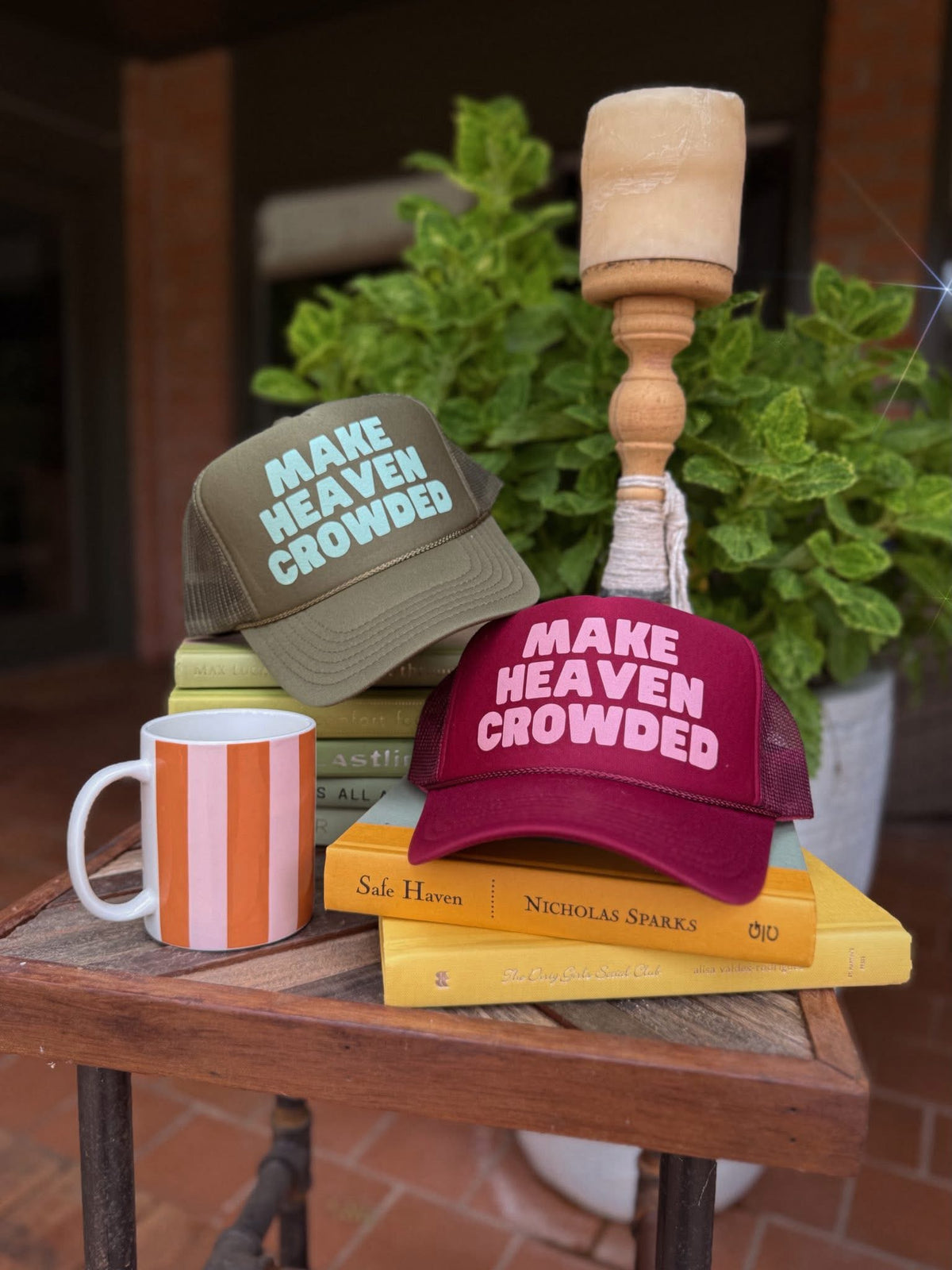 Oliver & Otis Make Heaven Crowded trucker hat in cranberry color with mesh back and adjustable strap.