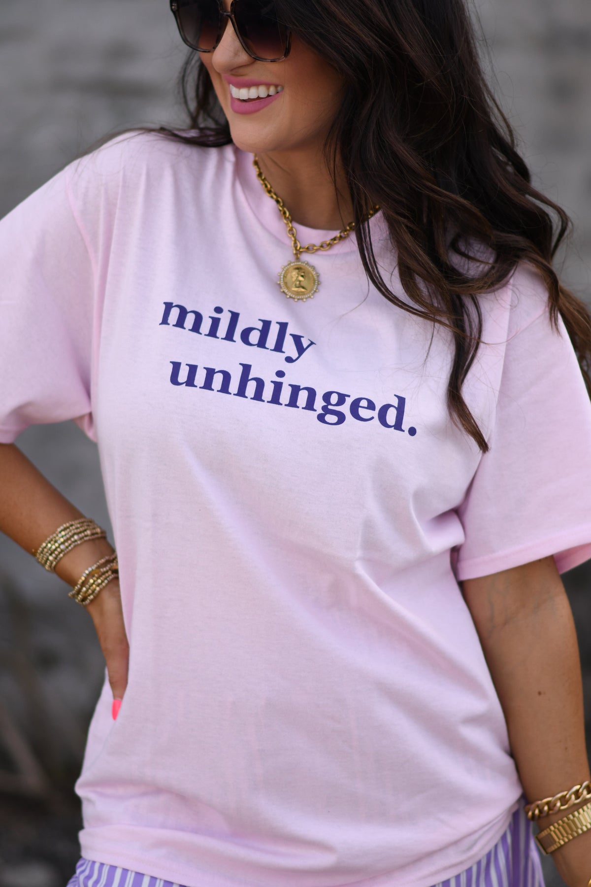 Baby pink "Mildly Unhinged Tee" by P&PD Wholesale, featuring a casual fit and graphic design on soft cotton fabric.