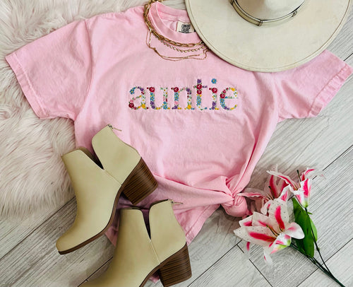 Light blue Auntie Floral Embroidered Tee by P&PD Wholesale featuring colorful floral embroidery on the front.