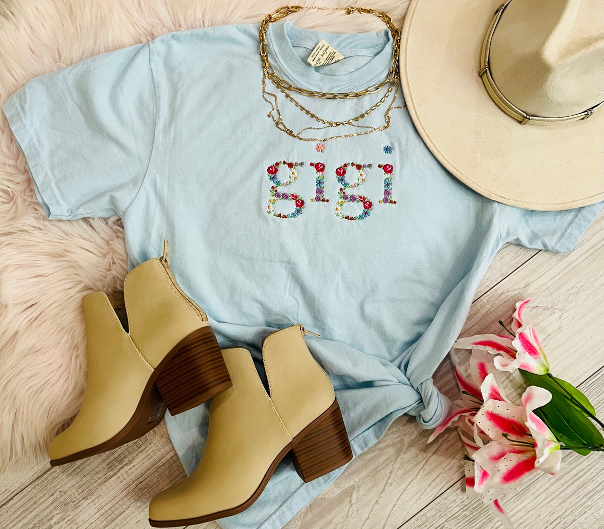 Blue Gigi floral embroidered T-shirt by P&PD Wholesale featuring intricate floral embroidery on soft fabric.