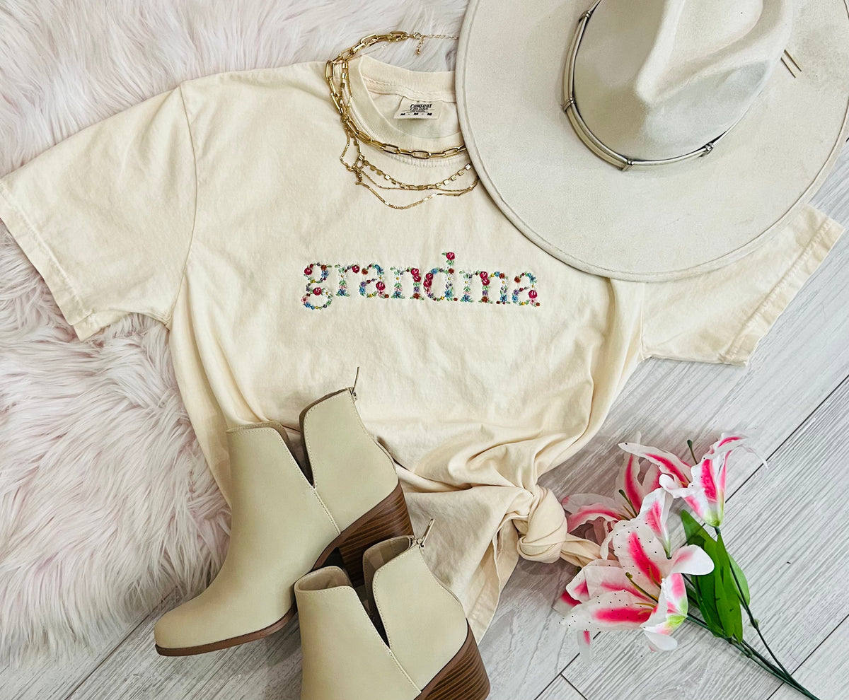 Blue Grandma Floral Embroidered T-shirt from P&PD Wholesale, featuring colorful floral embroidery on a casual tee.