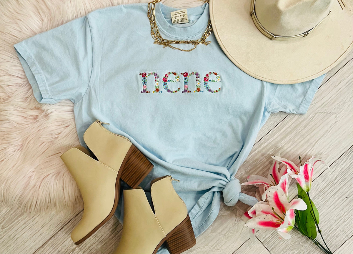 Blue Nene Floral Embroidered T-shirt by P&PD Wholesale featuring intricate floral embroidery on a casual tee.