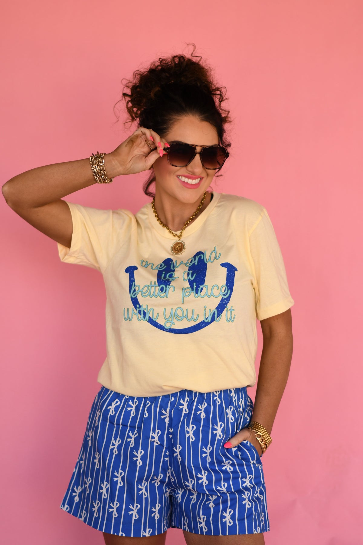 Yellow P&PD Wholesale T-shirt with the phrase "The World Is A Better Place With You In It" printed on the front.