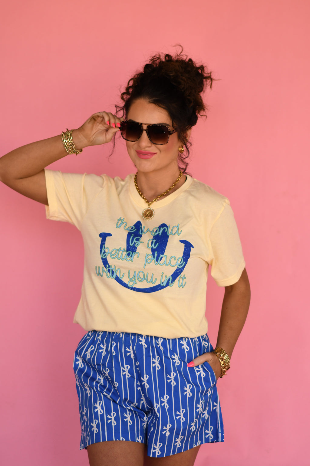 Light yellow P&PD Wholesale T-shirt with the slogan "The World Is A Better Place With You In It" printed on the front.