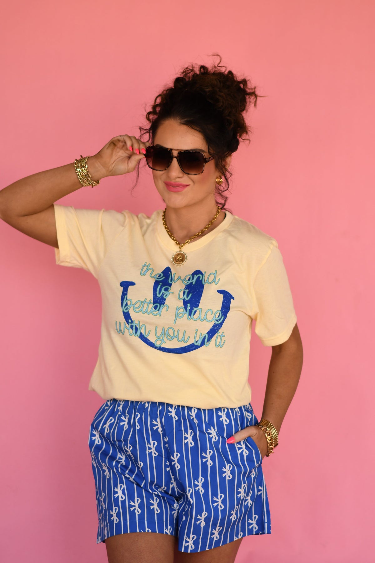 Light yellow P&PD Wholesale T-shirt with the slogan "The World Is A Better Place With You In It" printed on the front.