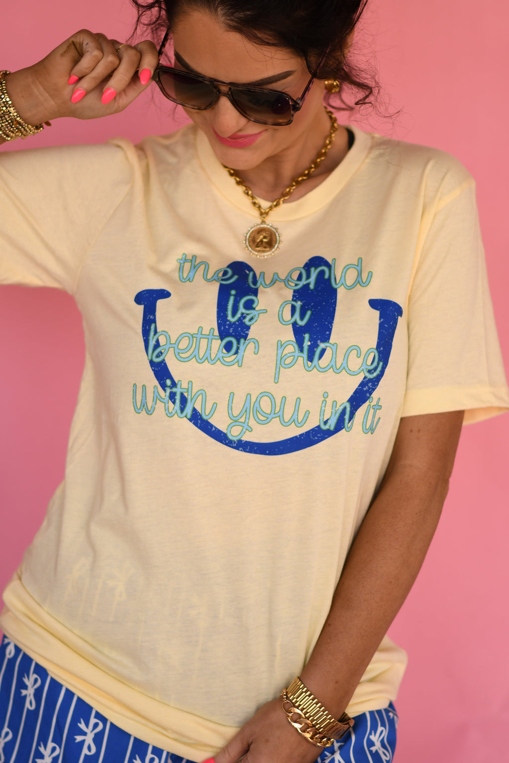 Butter yellow T-shirt by P&PD Wholesale with the phrase "The World Is A Better Place With You In It" printed on the front.