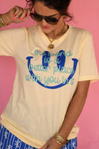 Butter yellow T-shirt by P&PD Wholesale with the phrase "The World Is A Better Place With You In It" printed on the front.
