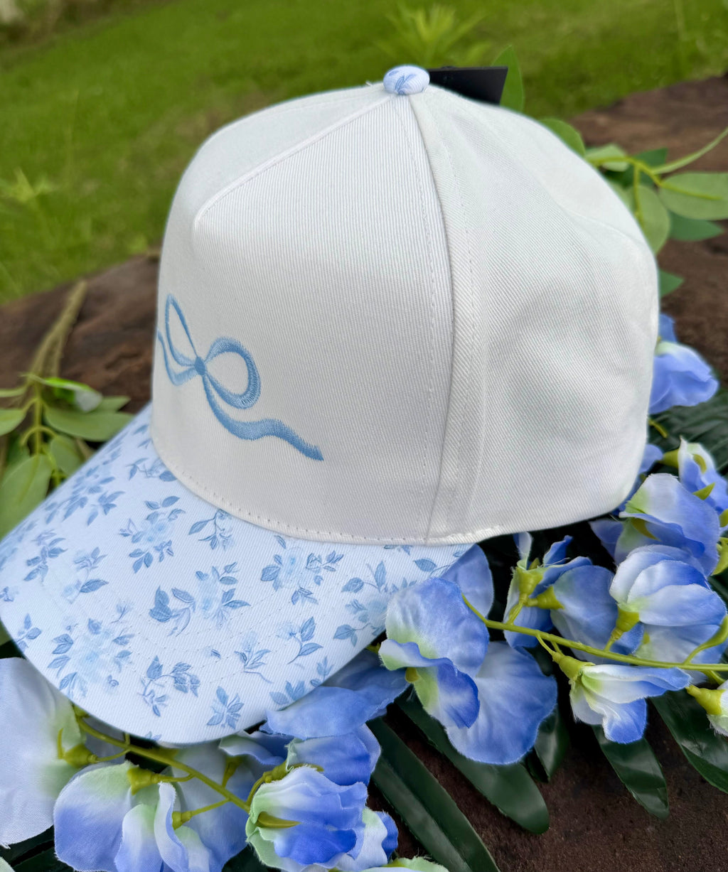 Blue embroidered floral bow hat by P&PD Wholesale featuring a decorative bow and floral embroidery for stylish wear.
