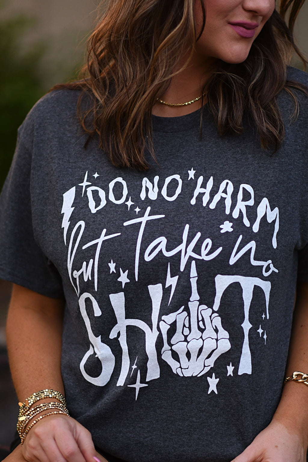 Black Do No Harm But Take No Shit T-shirt from P&PD Wholesale featuring bold white text on the front.