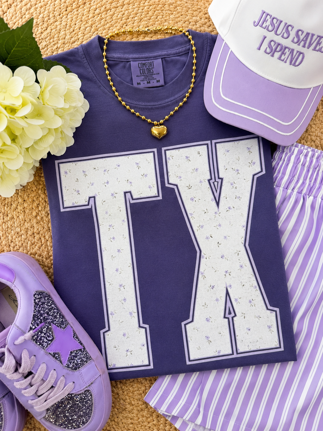 Purple floral state tee by P&PD Wholesale featuring a graphic design of Texas with floral accents.
