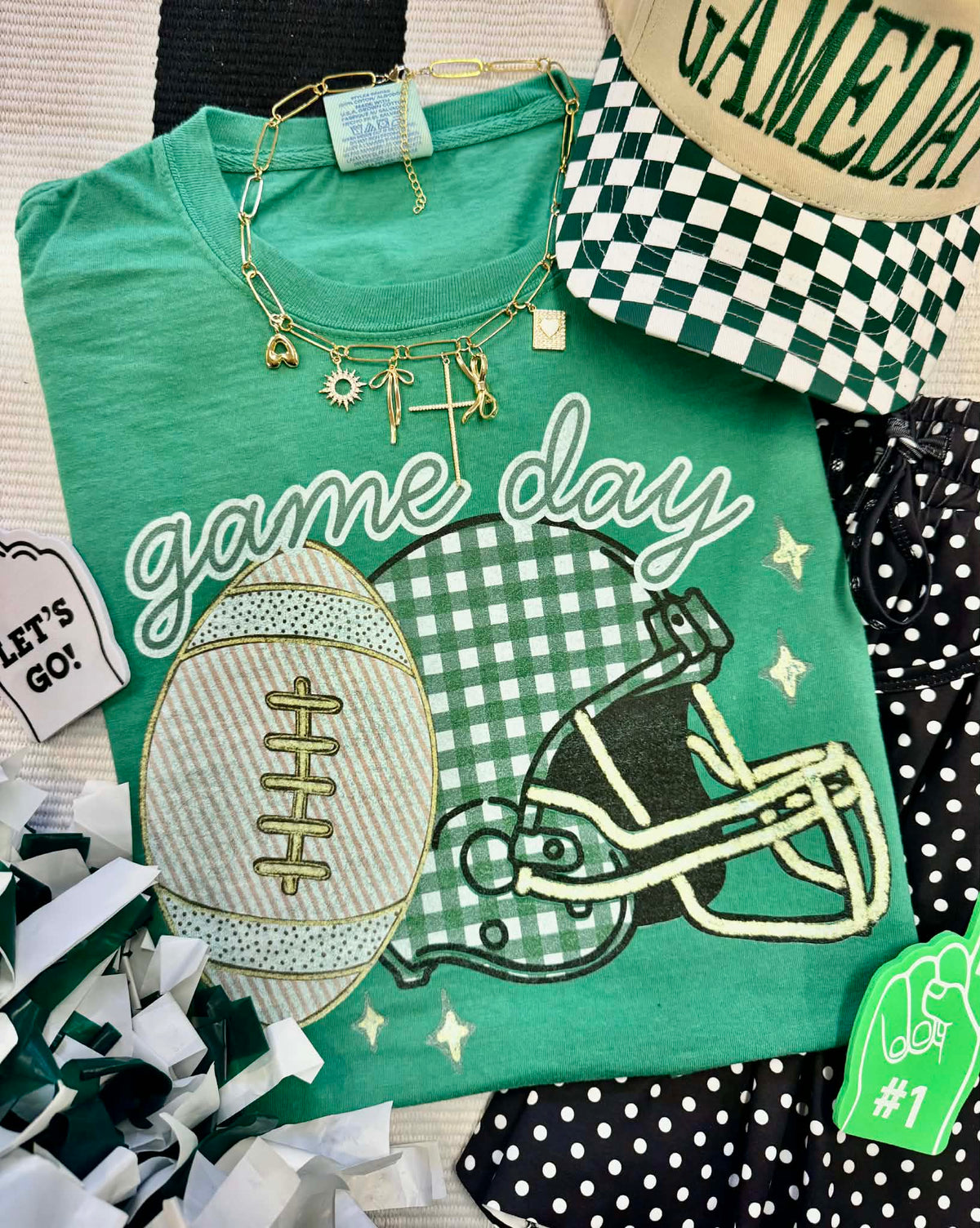 Royal Caribbean Game Day Green Gingham Helmet Tee from P&PD Wholesale, featuring a casual crewneck design with helmet graphic.