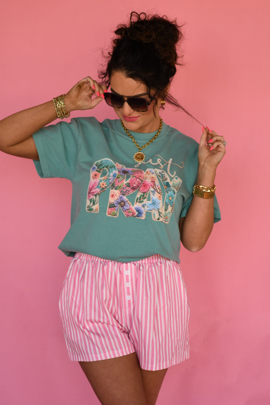 Seafoam green Just Pray Floral Rope Tee by P&PD Wholesale, held in hand, showing the front design and relaxed fit.
