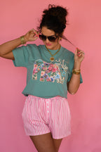 Seafoam green Just Pray Floral Rope Tee by P&PD Wholesale, held in hand, showing the front design and relaxed fit.