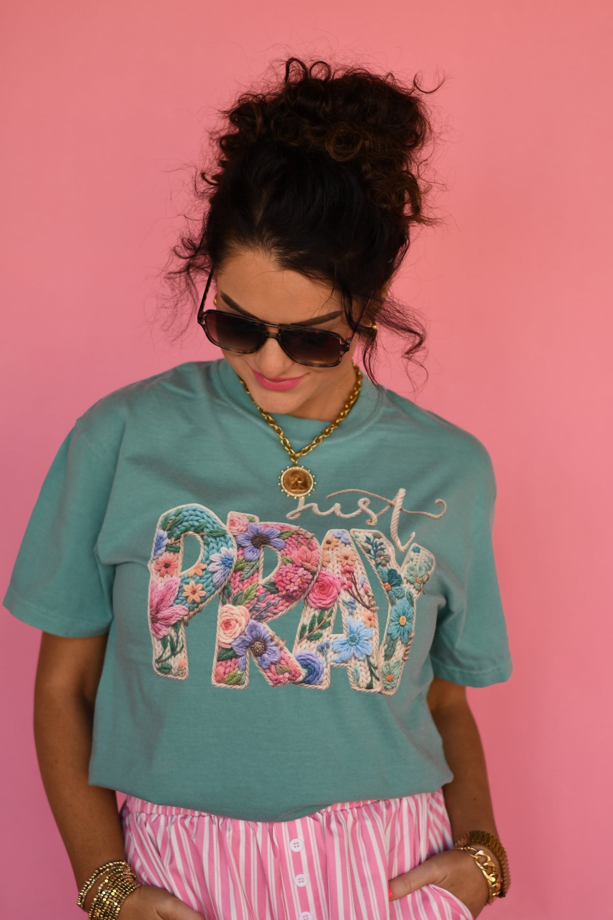 Seafoam green Just Pray Floral Rope Tee by P&PD Wholesale held in hand, showcasing the soft fabric and floral design.