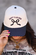 Black polka dot hat by P&PD Wholesale with "Happy To Be Here" text, stylish accessory featuring a playful pattern.