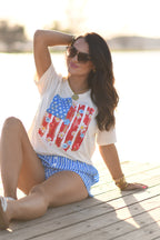 Small floral swatch flag tee by P&PD Wholesale featuring a colorful floral pattern on a casual T-shirt.