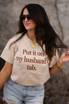 Tan "Put It On My Husband's Tab" T-shirt by P&PD Wholesale, casual men's tee with printed text design.