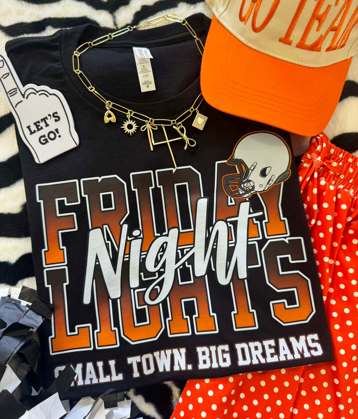 Orange Friday Night Lights T-shirt by P&PD Wholesale, featuring bold black lettering on a casual tee for teens and youth.