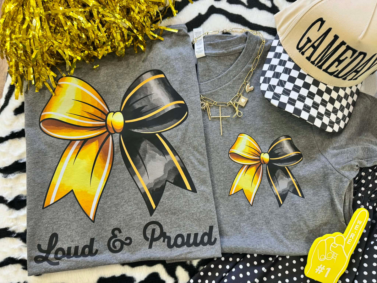 Deep heather gold bow graphic T-shirt by P&PD Wholesale, featuring bold "Loud & Proud" text in a casual tee style.