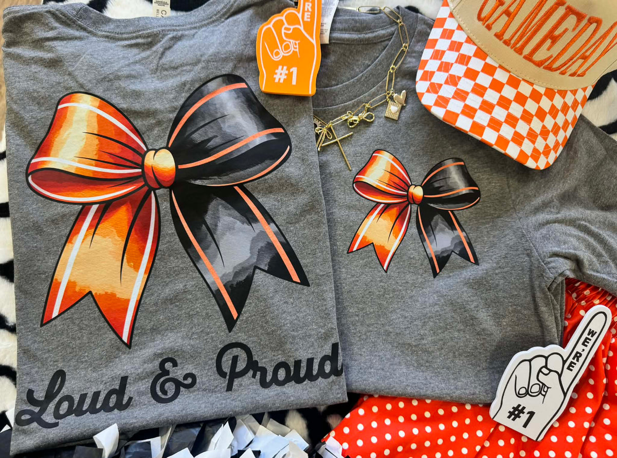 Deep heather orange Bow Tee by P&PD Wholesale featuring bold "Loud & Proud" text on a casual t-shirt.